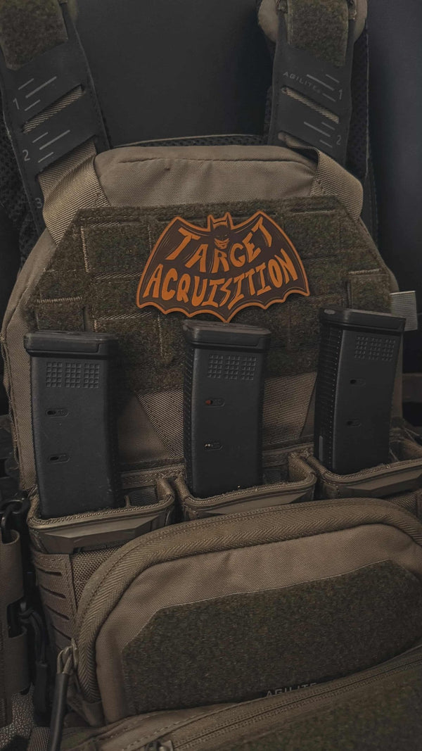 Tactical backpack with magazine pouches and a visible brand logo.